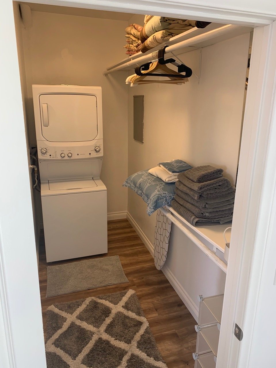 Laundry and closet with stacked washer and dryer