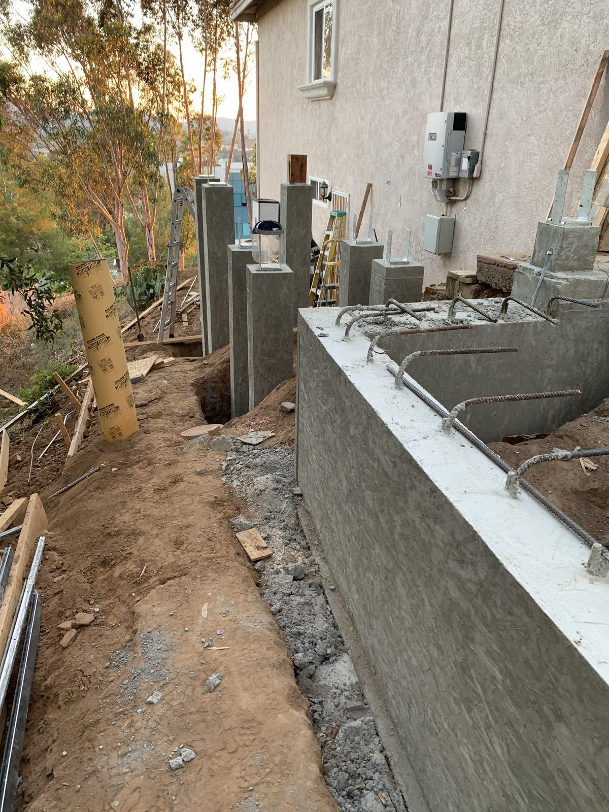 Poured concrete piers along the hillside